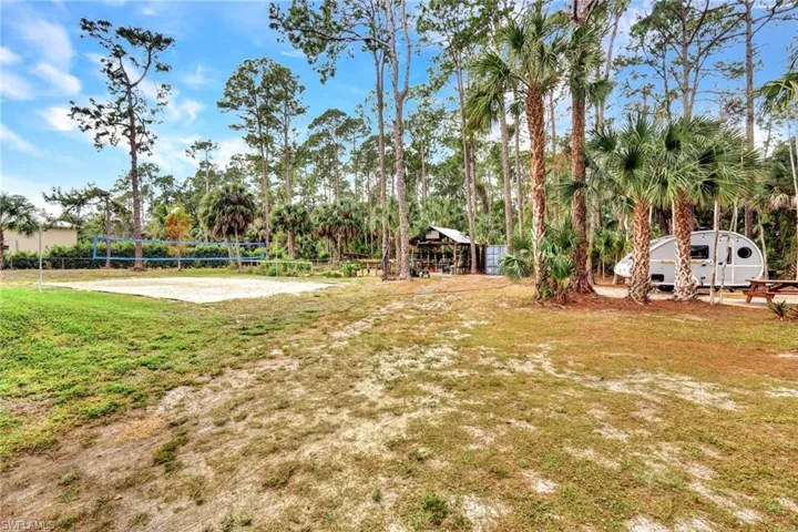View of green lawn featuring volleyball court and a gazebo