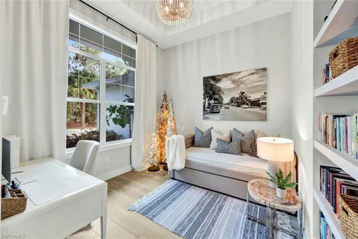 Home office featuring wood finished floors and a chandelier