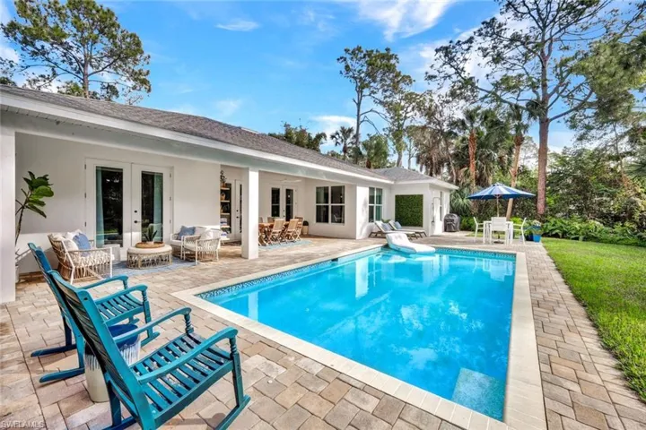 Swimming pool with french doors, outdoor dining space, and a patio area