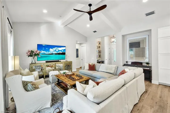 Living room featuring ceiling fan, light wood-type flooring, and recessed lighting