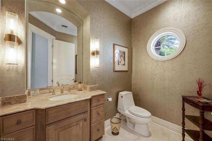 Powder room, located near formal living room and den.
