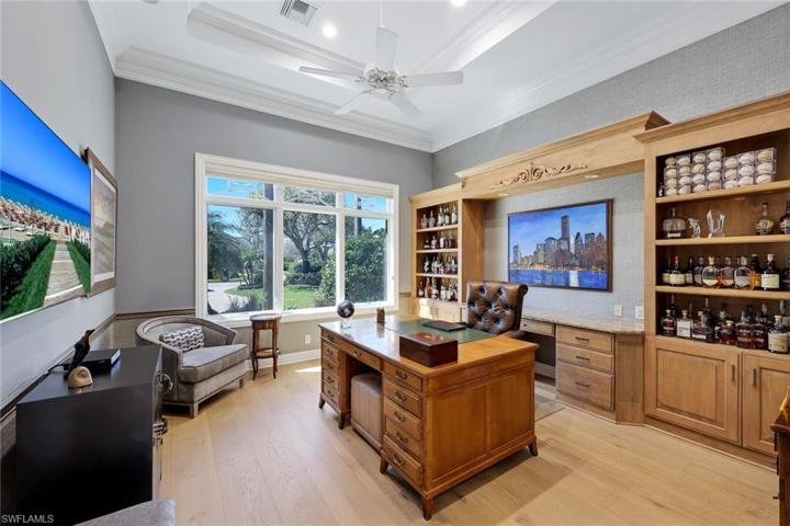 Den/study with custom built shelves and cabinetry.