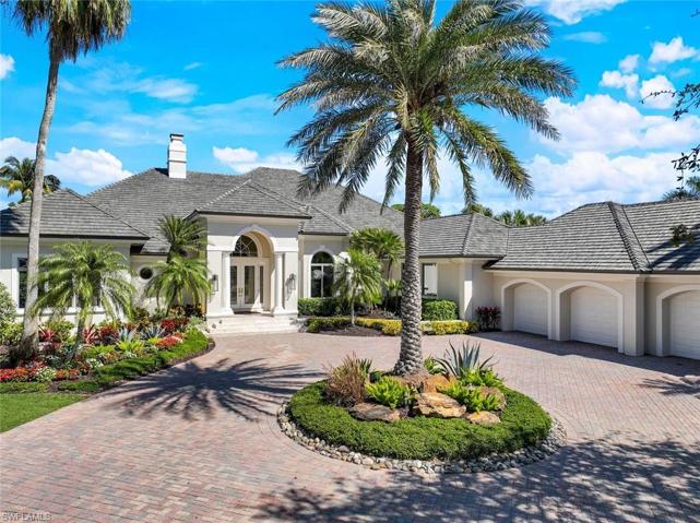 Beautifully adorned by tall palm trees, this home is one of Bonita Bay's finest, located in the esteemed community of Spring Ridge.