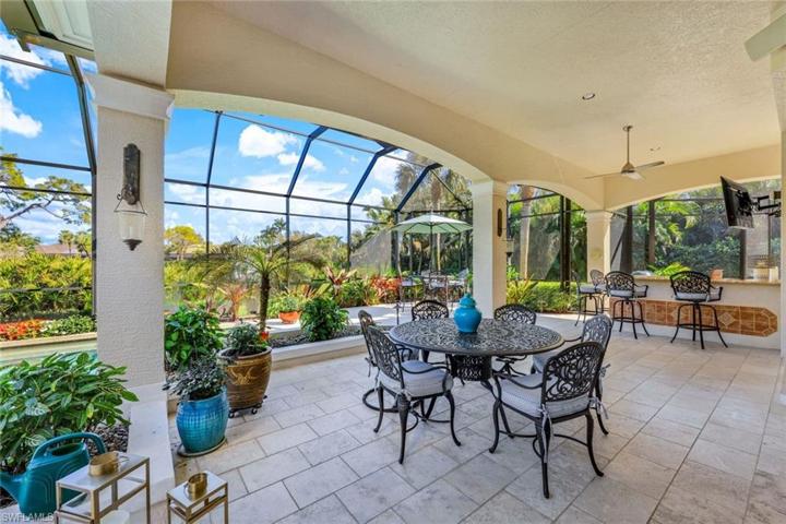 The covered space offered in this home is remarkable. Notice the bar area complete with a large screen TV for relaxing with your favorite beverage and the team of your choice!