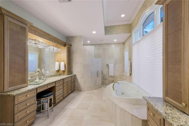 Prmary bathroom with separate vanities, HUGE walk in shower, & soaking tub.