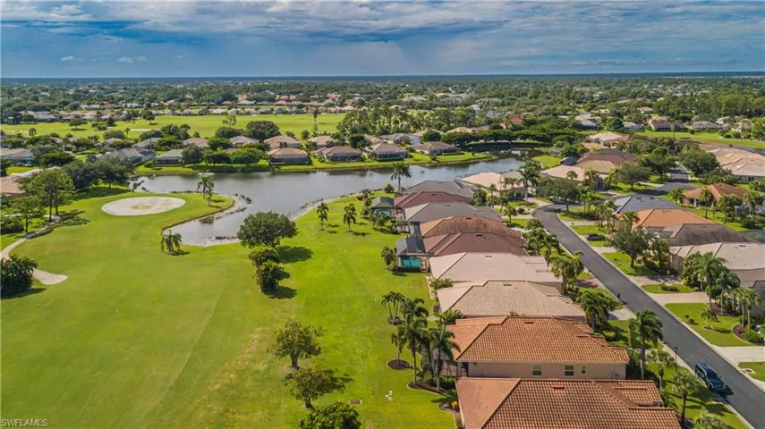 Drone / aerial view with golf course and water view