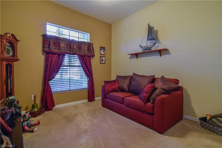 Guest Bedroom with large window, ceiling fan, and carpeting