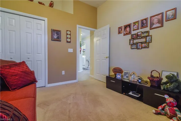 Guest Bedroom with large window, ceiling fan, and carpeting