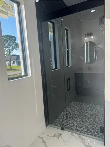 Bathroom with walk in shower and tile floors