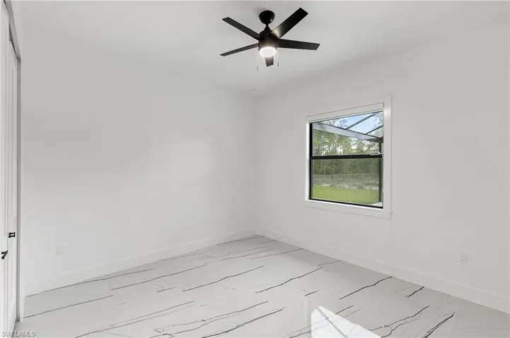 Empty room featuring ceiling fan