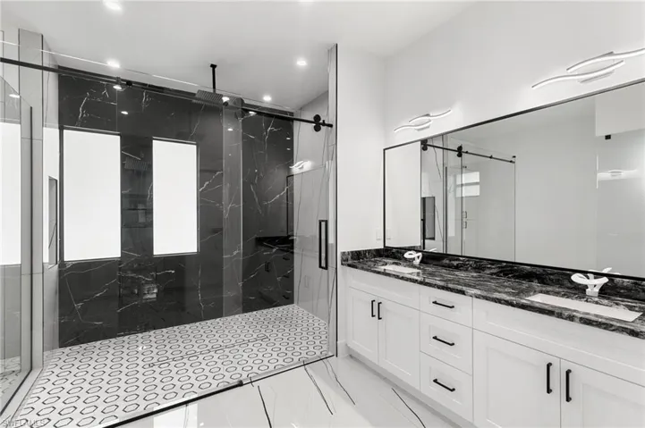 Bathroom featuring vanity and a shower with shower door