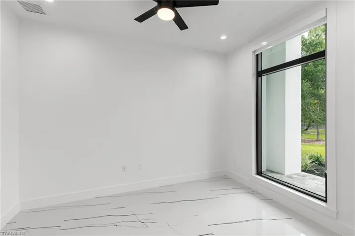 Empty room featuring ceiling fan