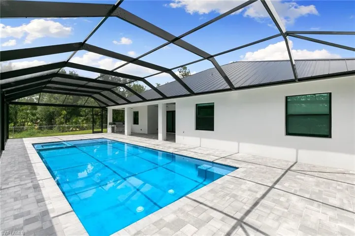 View of pool featuring a patio and a lanai