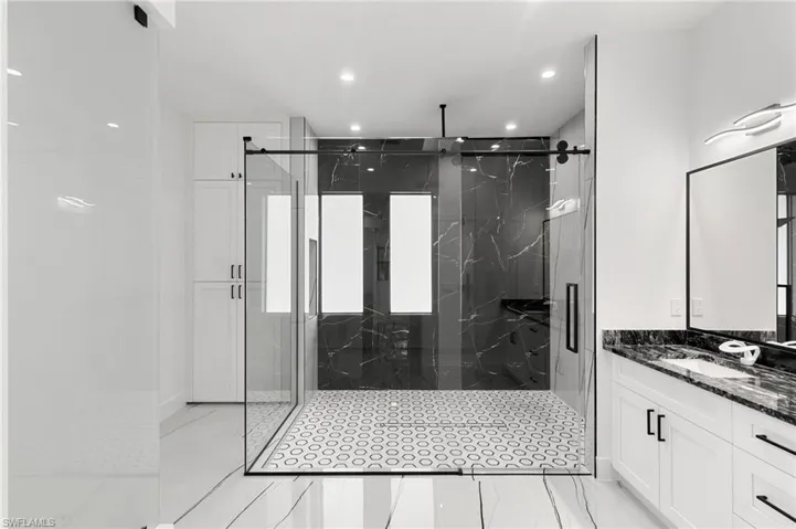 Bathroom with a shower with door and vanity