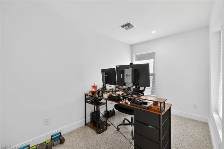 Office featuring dark speckled floor and recessed lighting