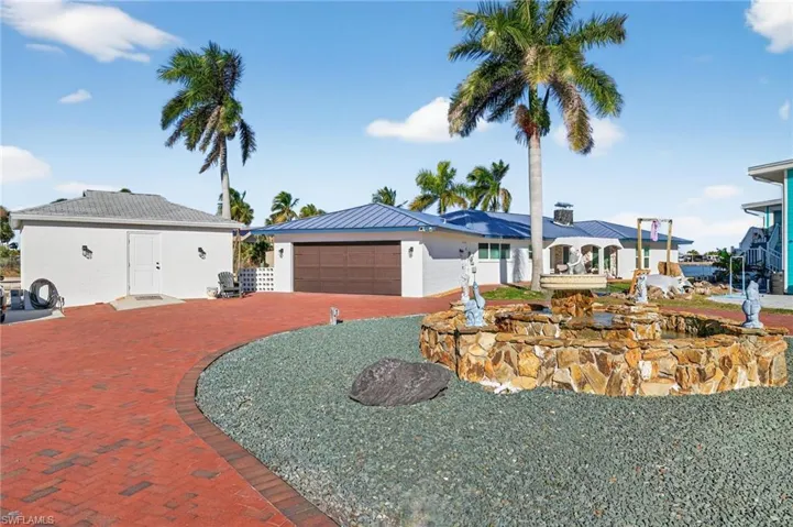 View of front of home with an attached garage and driveway