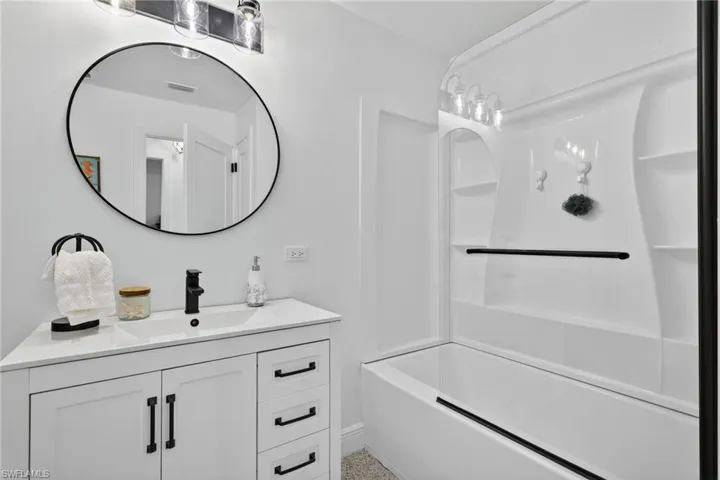 Bathroom with vanity and tub / shower combination