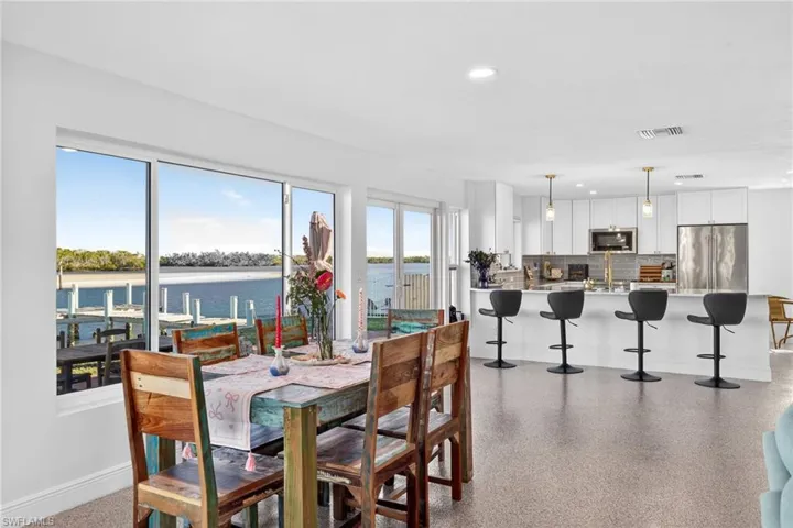 Dining room featuring recessed lighting and a water view