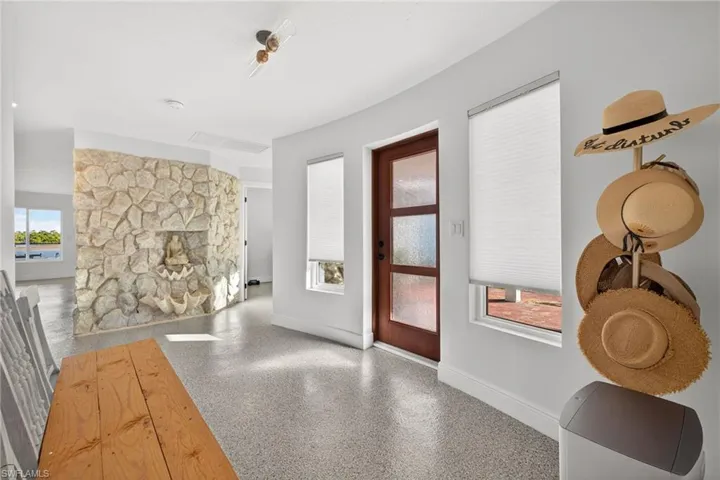 Entrance foyer with baseboards and speckled floor