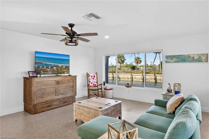 Living room featuring a ceiling fan and recessed lighting