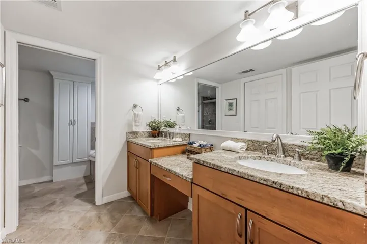Bathroom featuring double vanity and a shower