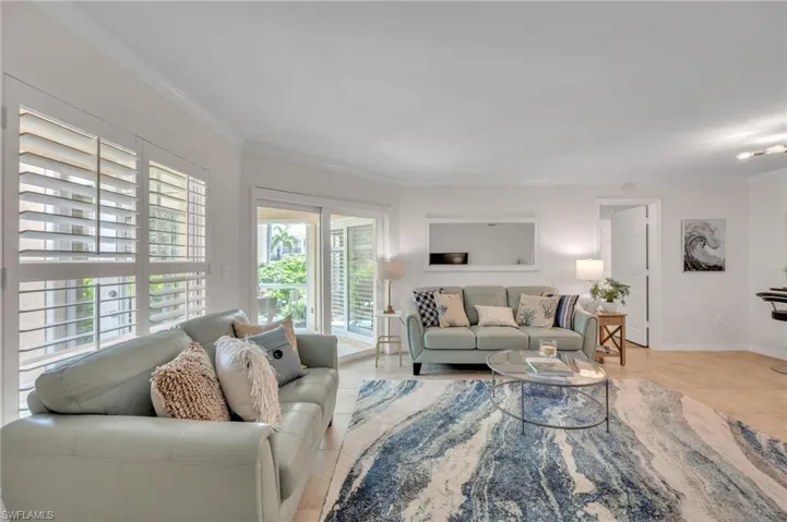 Living area featuring crown molding and baseboards