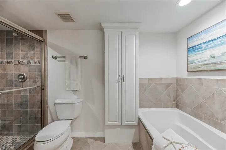 Bathroom featuring a bath, a stall shower, tile patterned floors, and recessed lighting