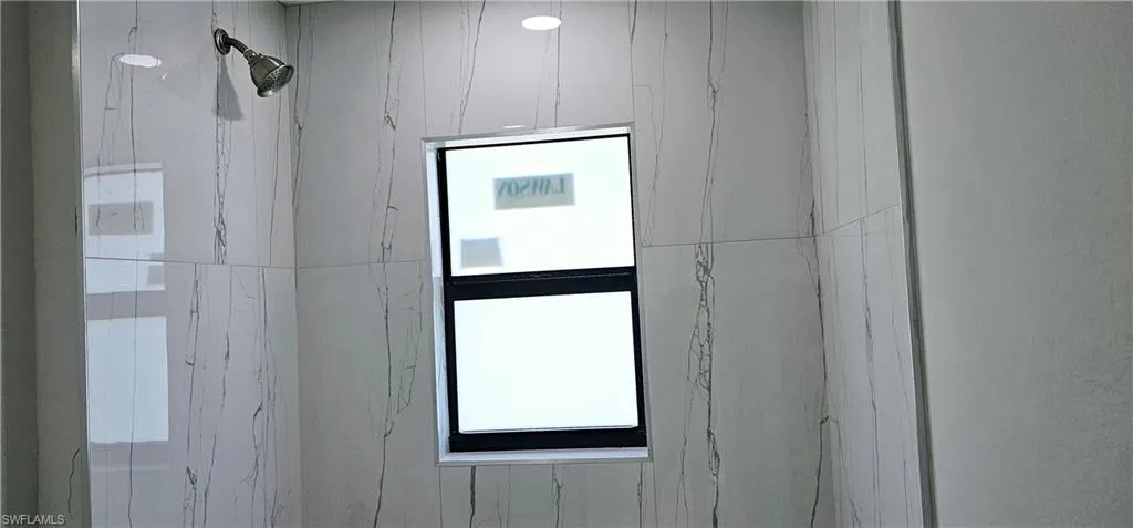 Room details with a marble finish shower