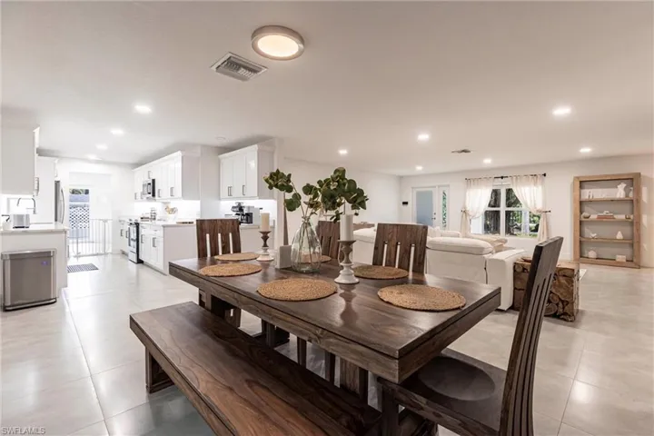Dining space featuring light tile patterned floors and recessed lighting