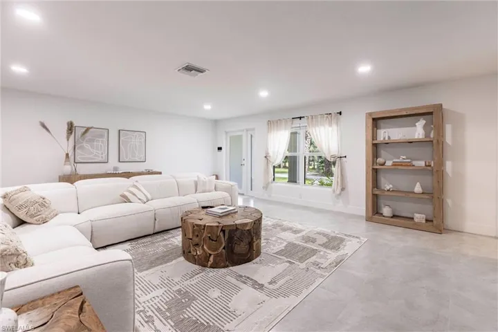 Living room with recessed lighting and finished concrete floors