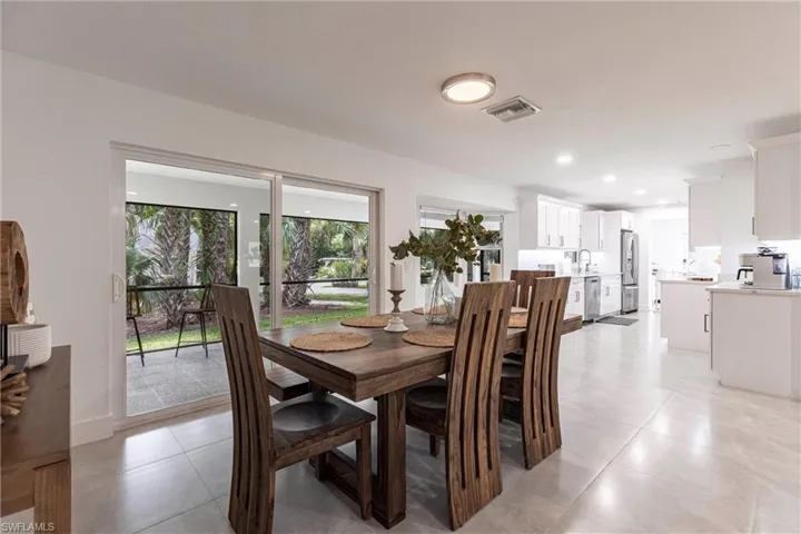 Dining space featuring light tile patterned flooring and recessed lighting