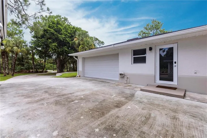 Garage featuring concrete driveway