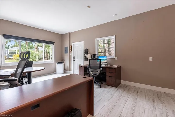 Office space featuring healthy amount of natural light and light wood-type flooring