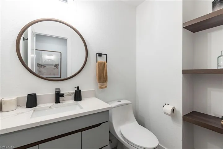 Half bath featuring toilet and vanity