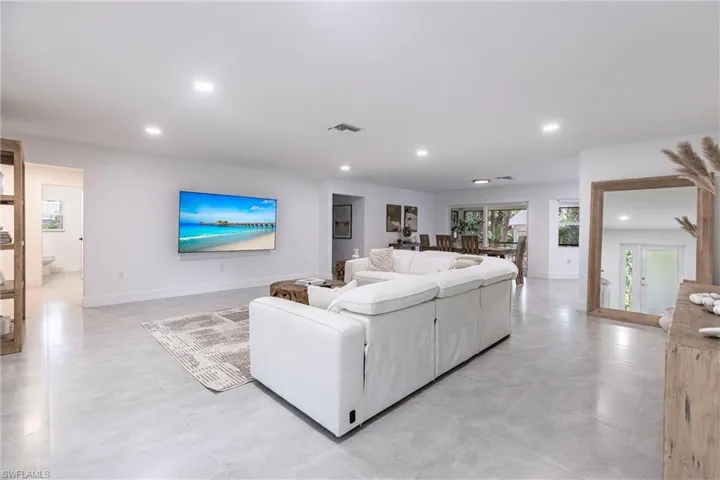 Living area with recessed lighting and baseboards