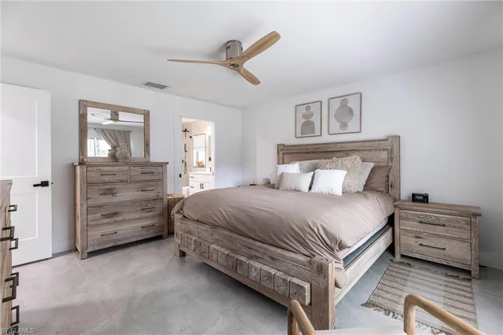 Bedroom featuring ceiling fan and ensuite bathroom