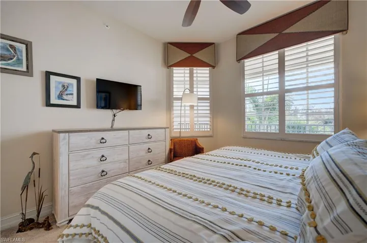Carpeted bedroom with ceiling fan