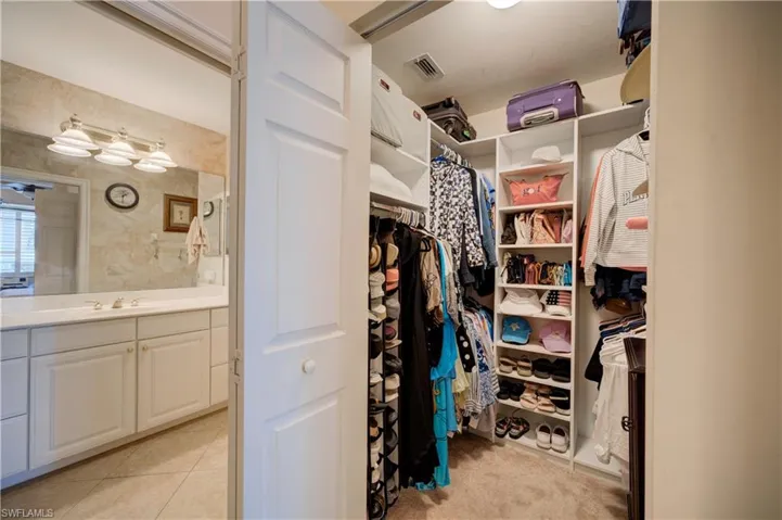 Spacious closet with sink and light tile patterned flooring
