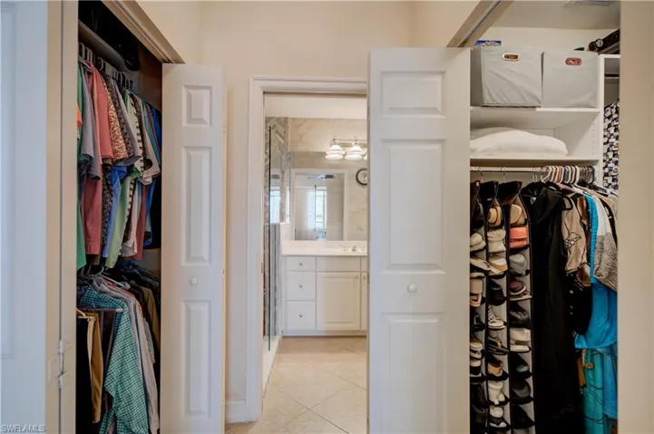 Walk in closet with sink and light tile patterned flooring