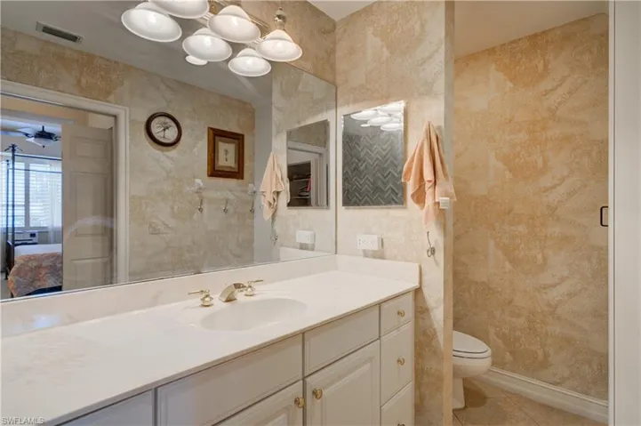 Bathroom with tile patterned flooring, vanity, and toilet