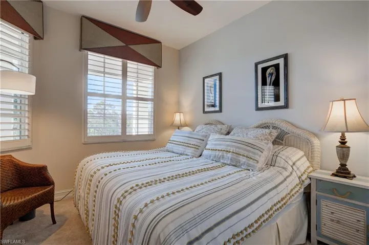 Carpeted bedroom with ceiling fan