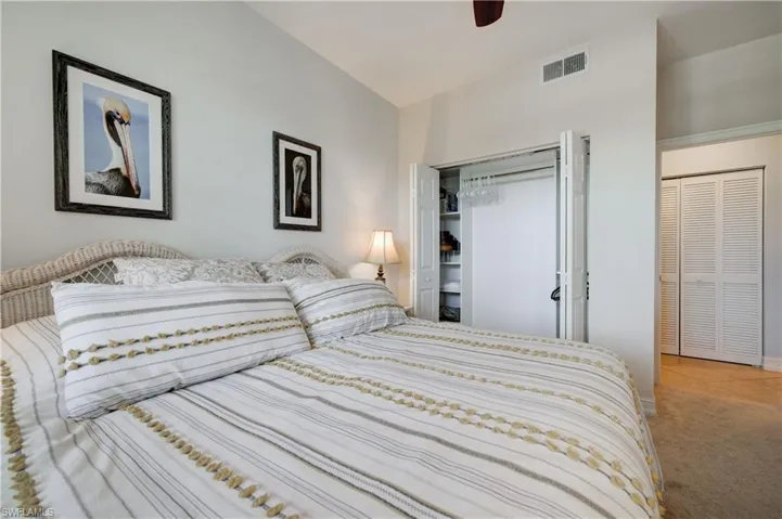 Bedroom with ceiling fan, carpet floors, and a closet