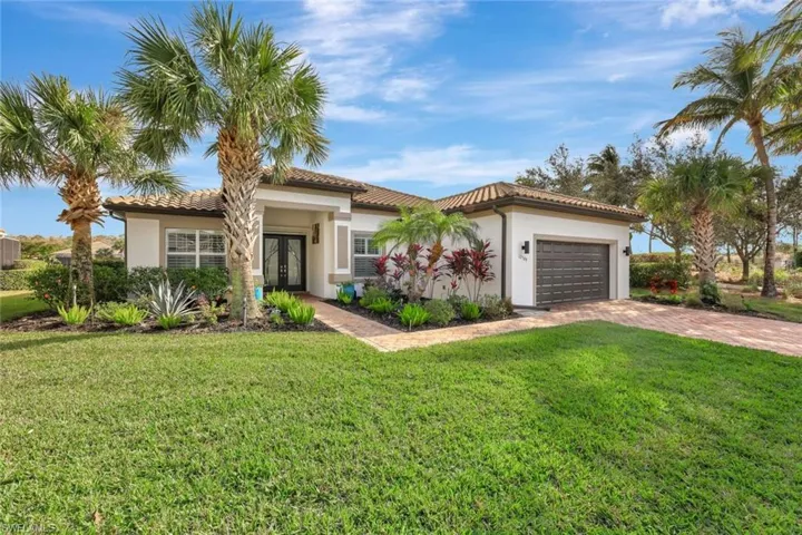 Mediterranean / spanish house featuring french doors, a garage, and a front yard