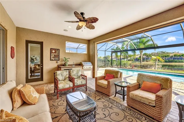Sunroom / solarium featuring a water view and ceiling fan