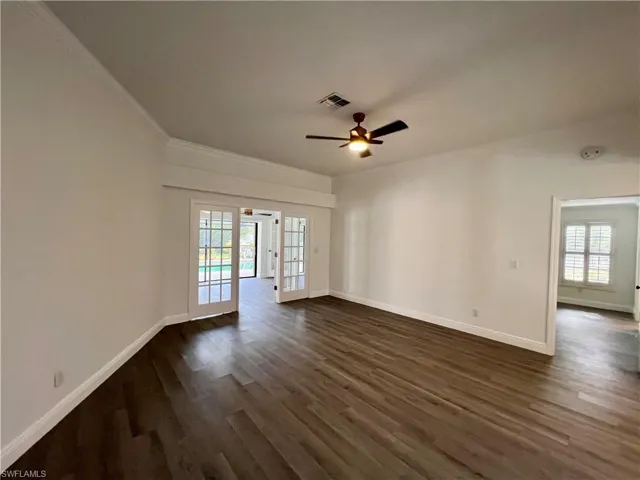 Formal Living room with crown molding and French doors.