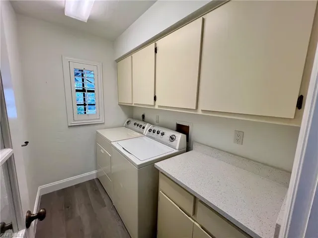 Laundry area with extra cabinets and counter space with washer and dryer.