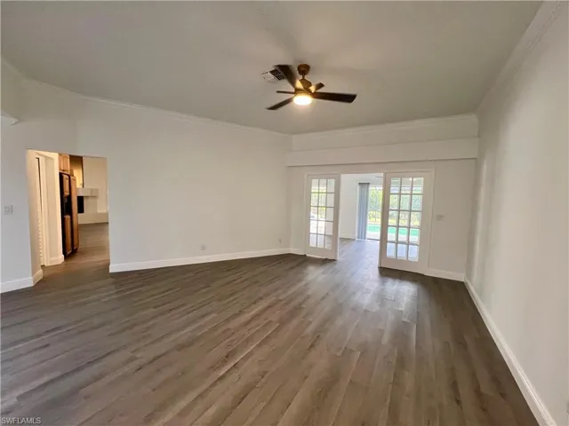 Formal Living room with crown molding and French doors.