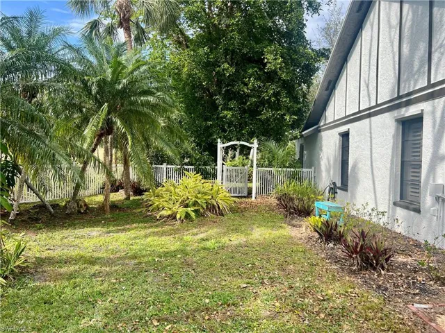 View of yard with white PVC fencing.