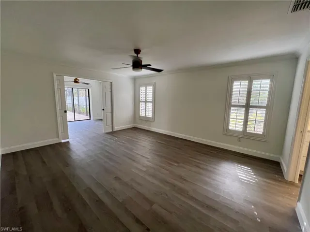 Primary Bedroom with French doors to the den and crown molding.