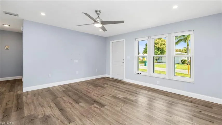 Empty room with a ceiling fan, light wood-style floors, and recessed lighting